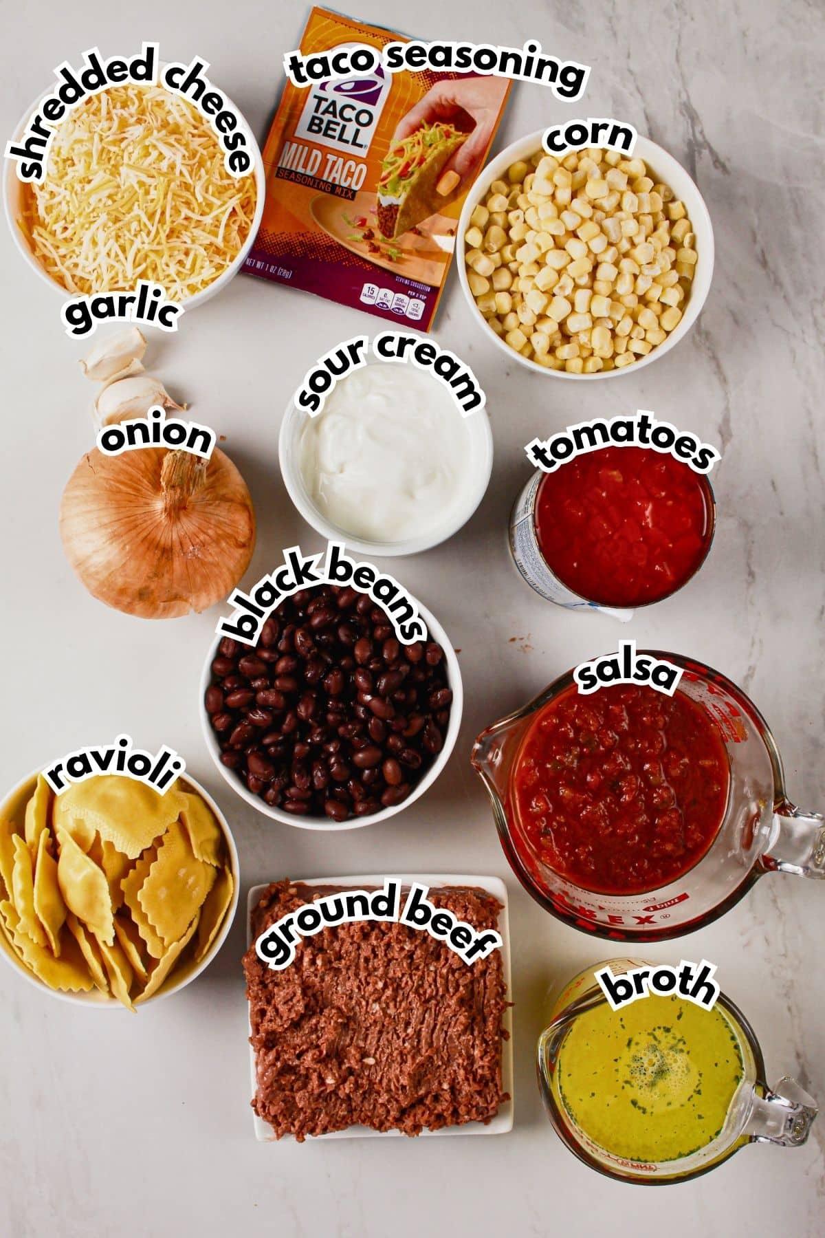 Bowls of ingredients labelled with text on a counter.