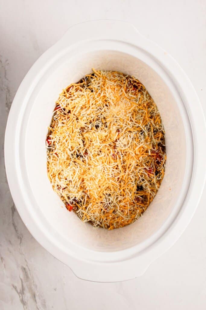 Cheese on top of casserole in crockpot.