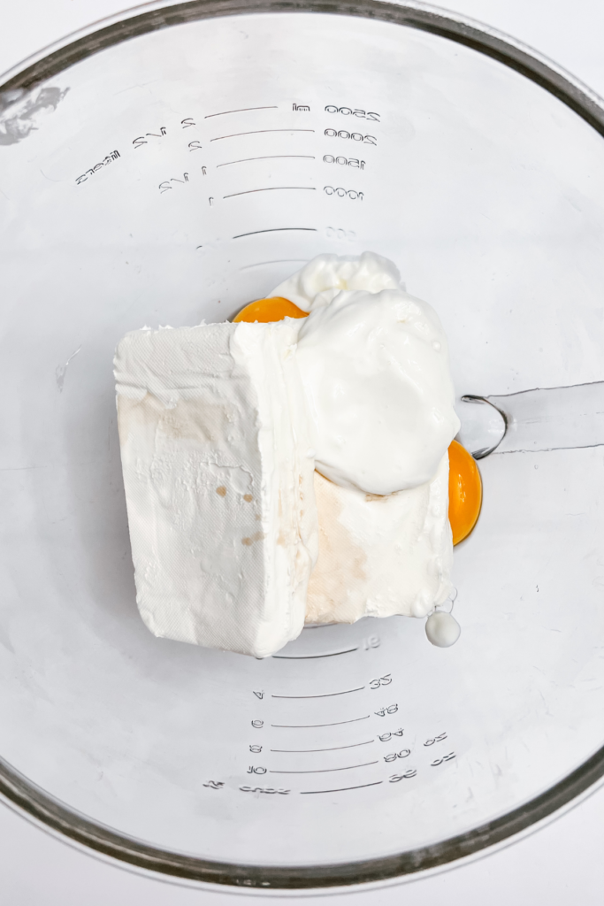 adding the eggs and vanilla to the mixing bowl