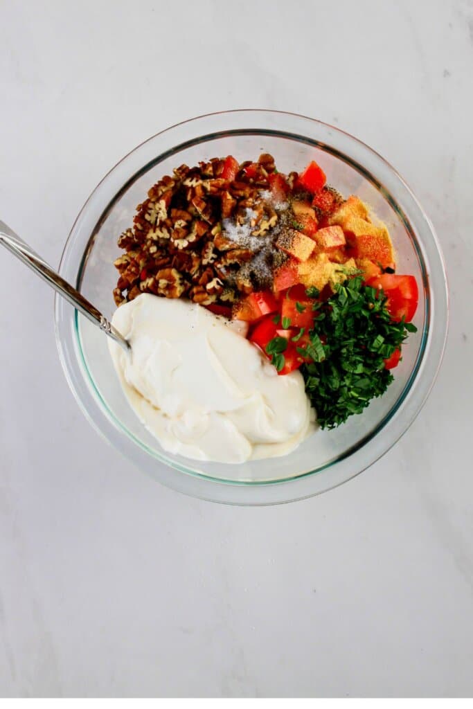 Ingredients being mixed in a glass bowl.