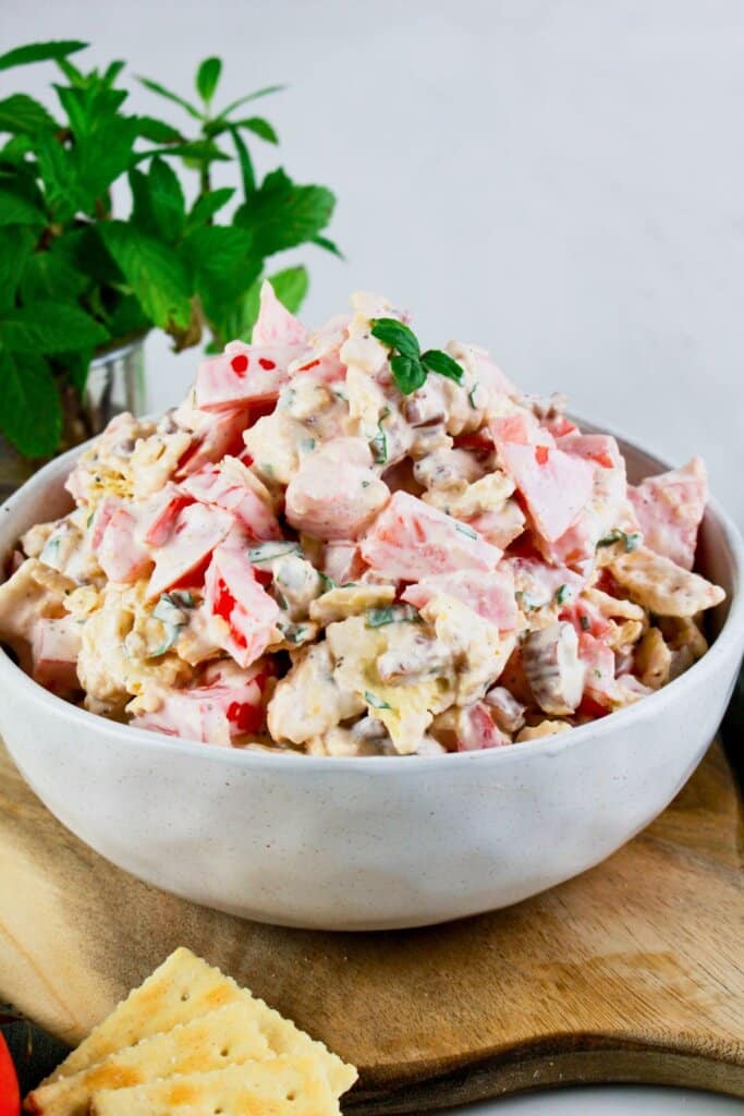 Tomato cracker salad in a white bowl.