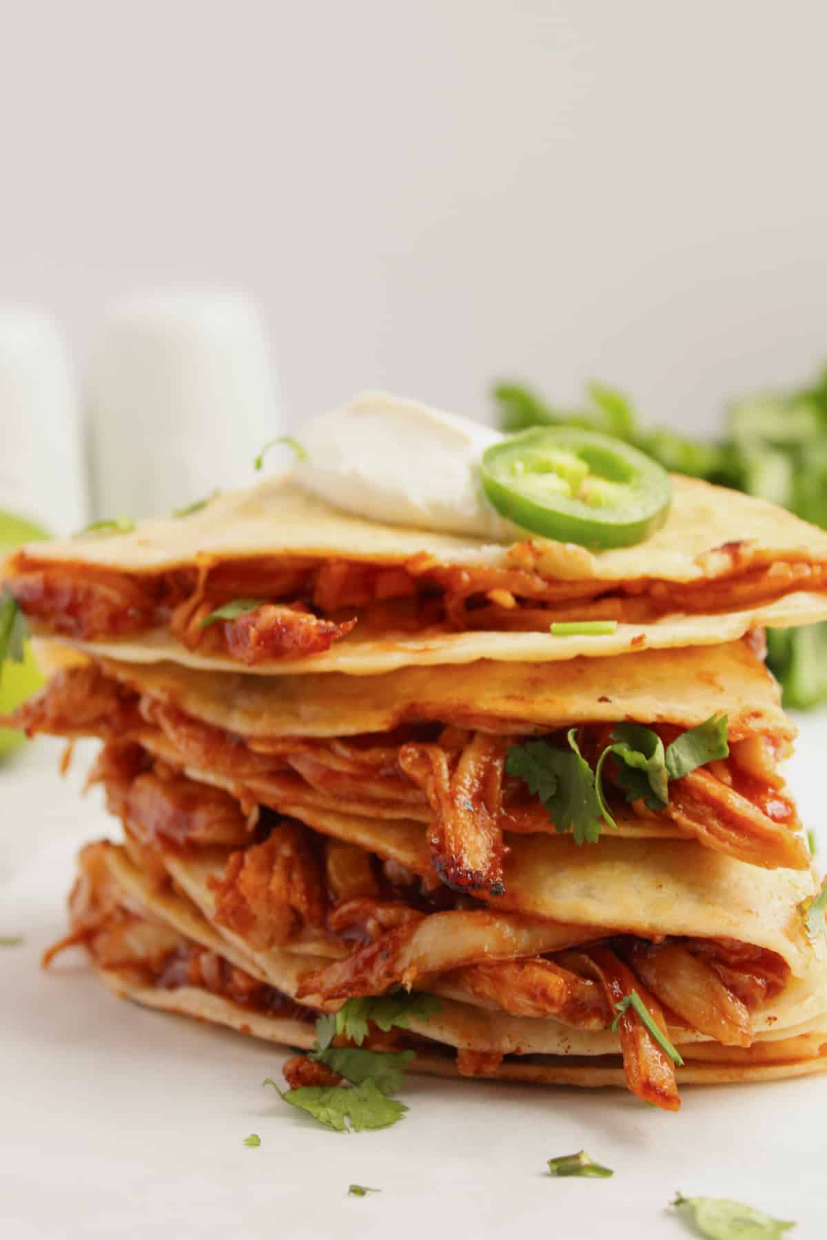 BBQ chicken quesadilla pieces stacked on top of each other.