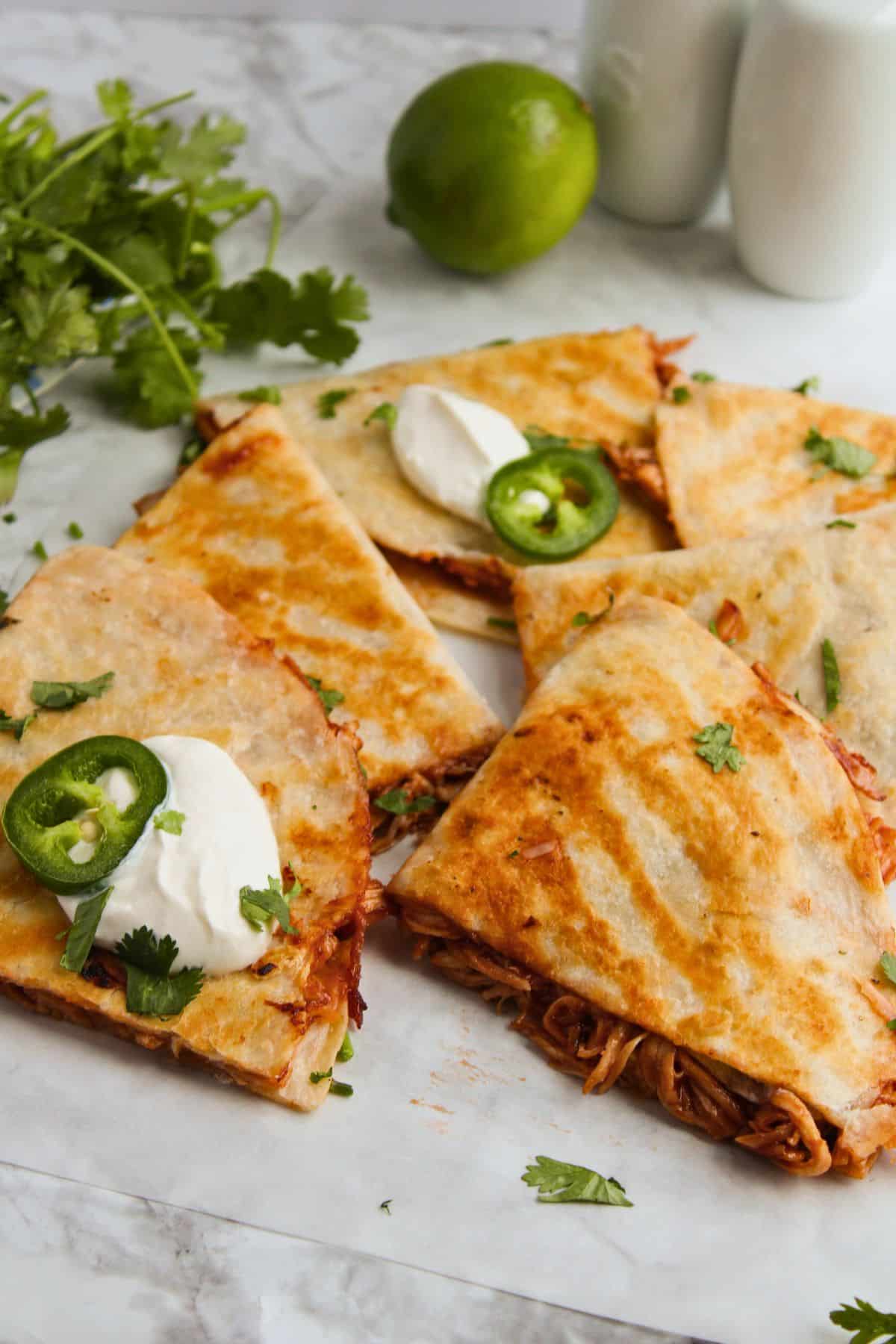 BBQ chicken quesadilla pieces on a counter.