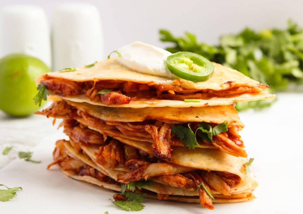 BBQ chicken quesadilla pieces stacked on top of each other.