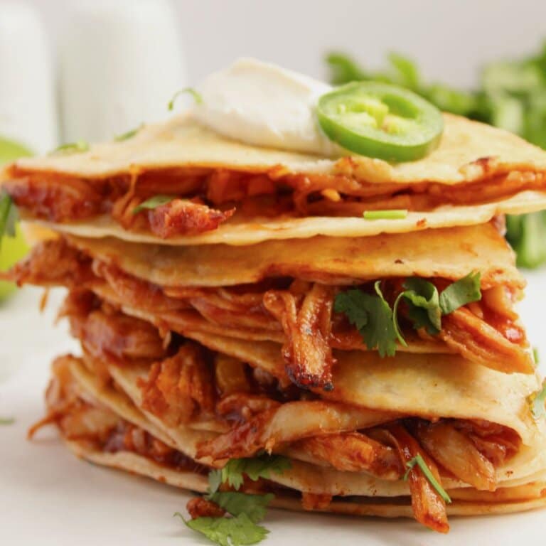 BBQ chicken quesadilla pieces stacked on top of each other.