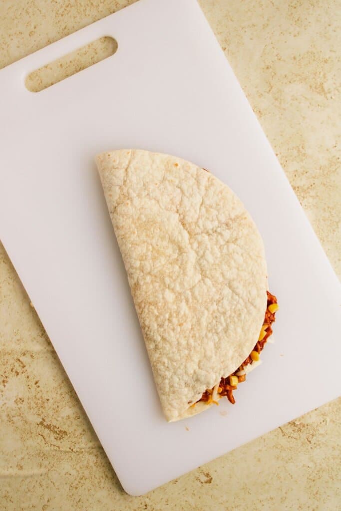 Stuffed tortilla folded in half.