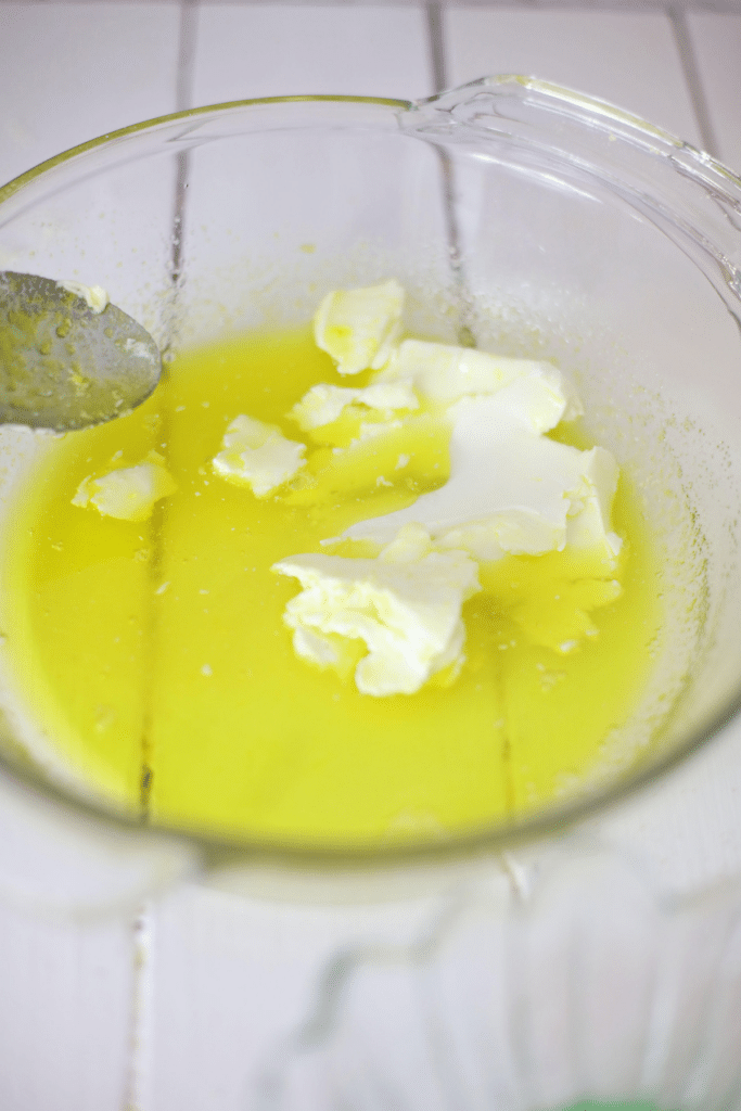 Adding cream cheese to the jello mixture.