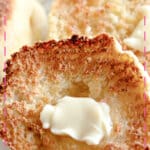 Butter being spread on an english muffin.