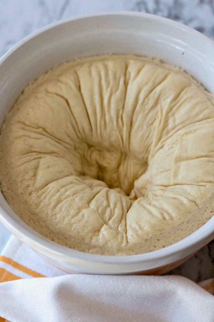 Dough being punched down in a bowl.