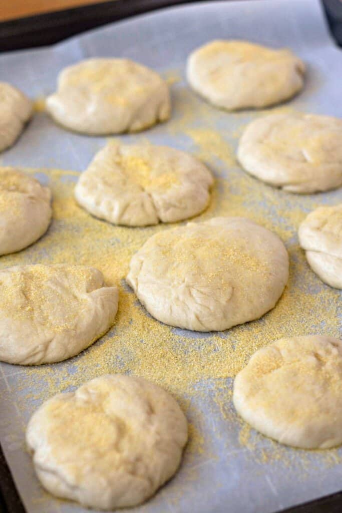 Dough balls on a parchment lined baking sheet.