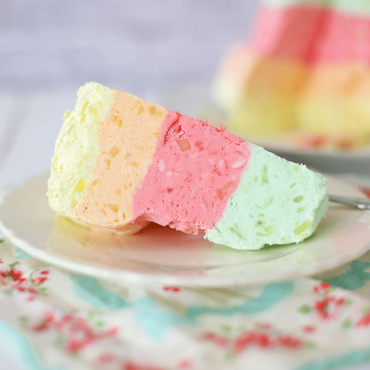 Close up of jello salad on a white plate.
