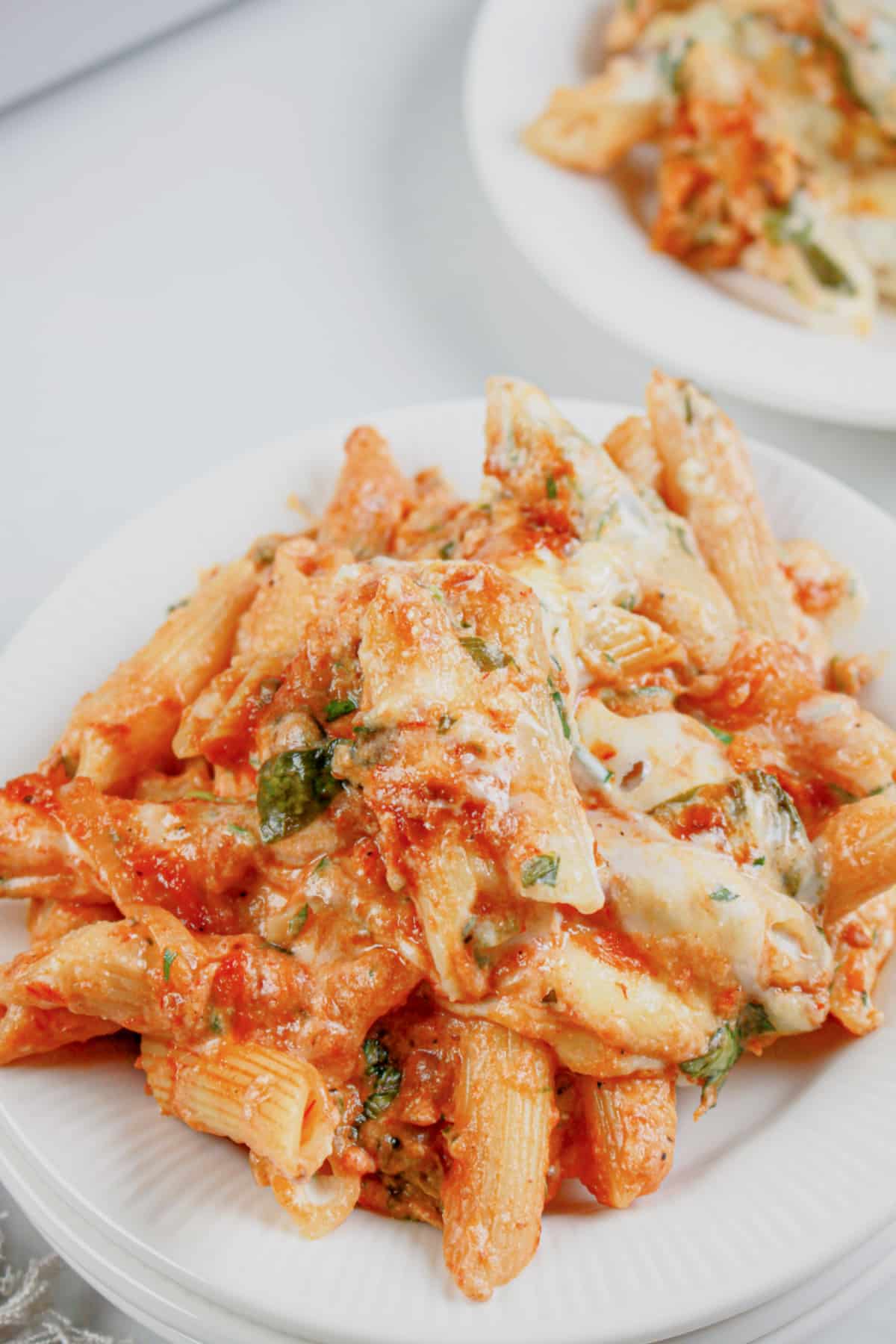 Serving of baked ziti on a small white plate.
