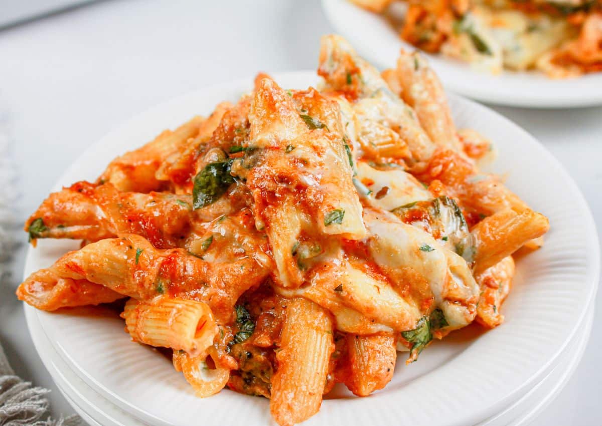 Serving of baked ziti on a small white plate.