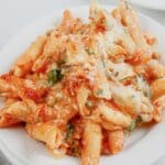 Serving of baked ziti on a small white plate.