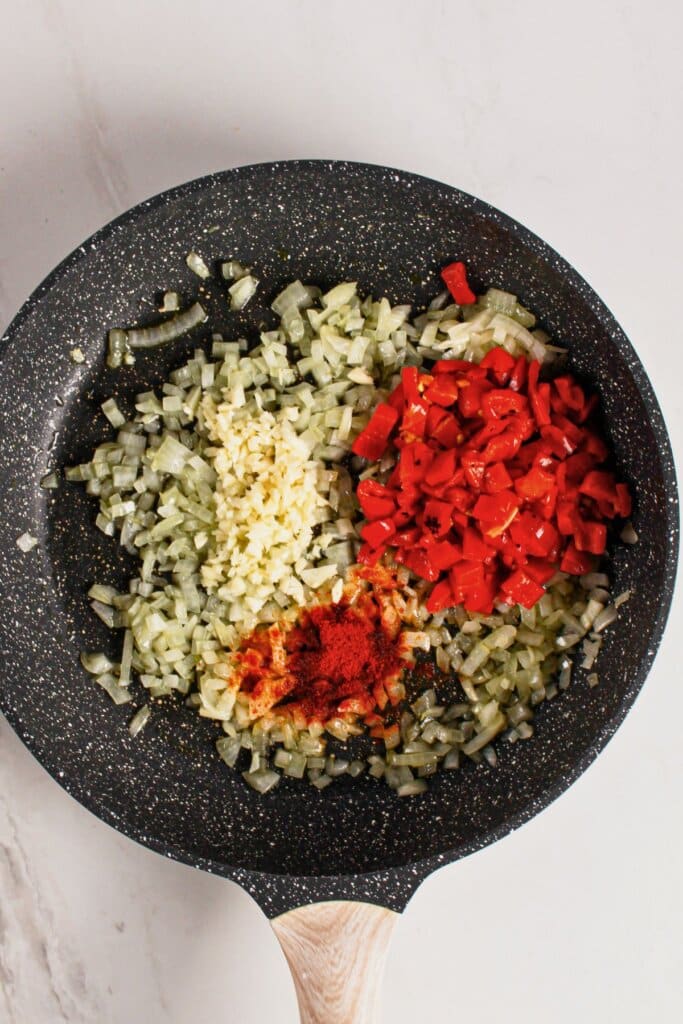 Onions and peppers in a skillet.