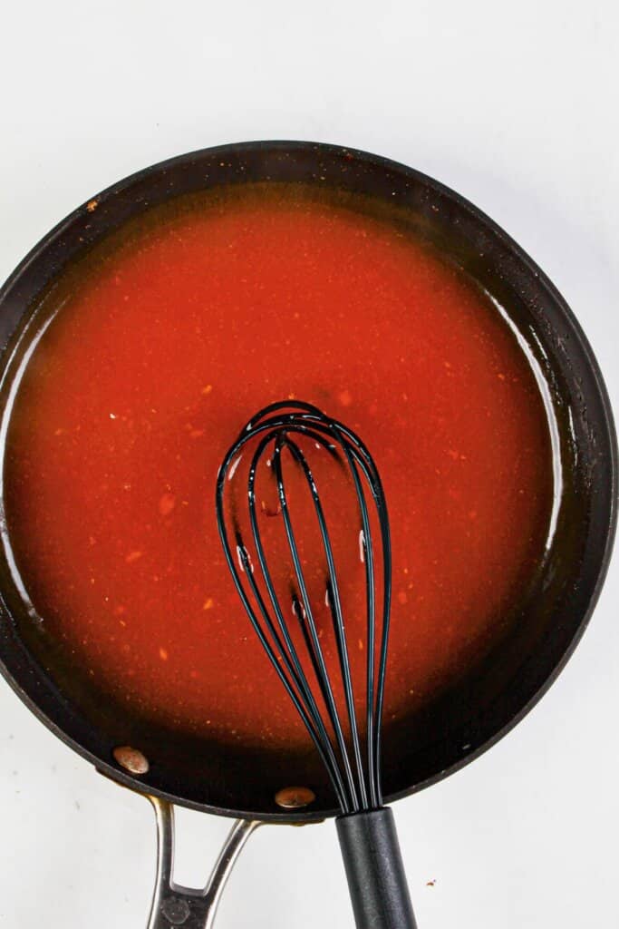 Sauce being mixed in a skillet.